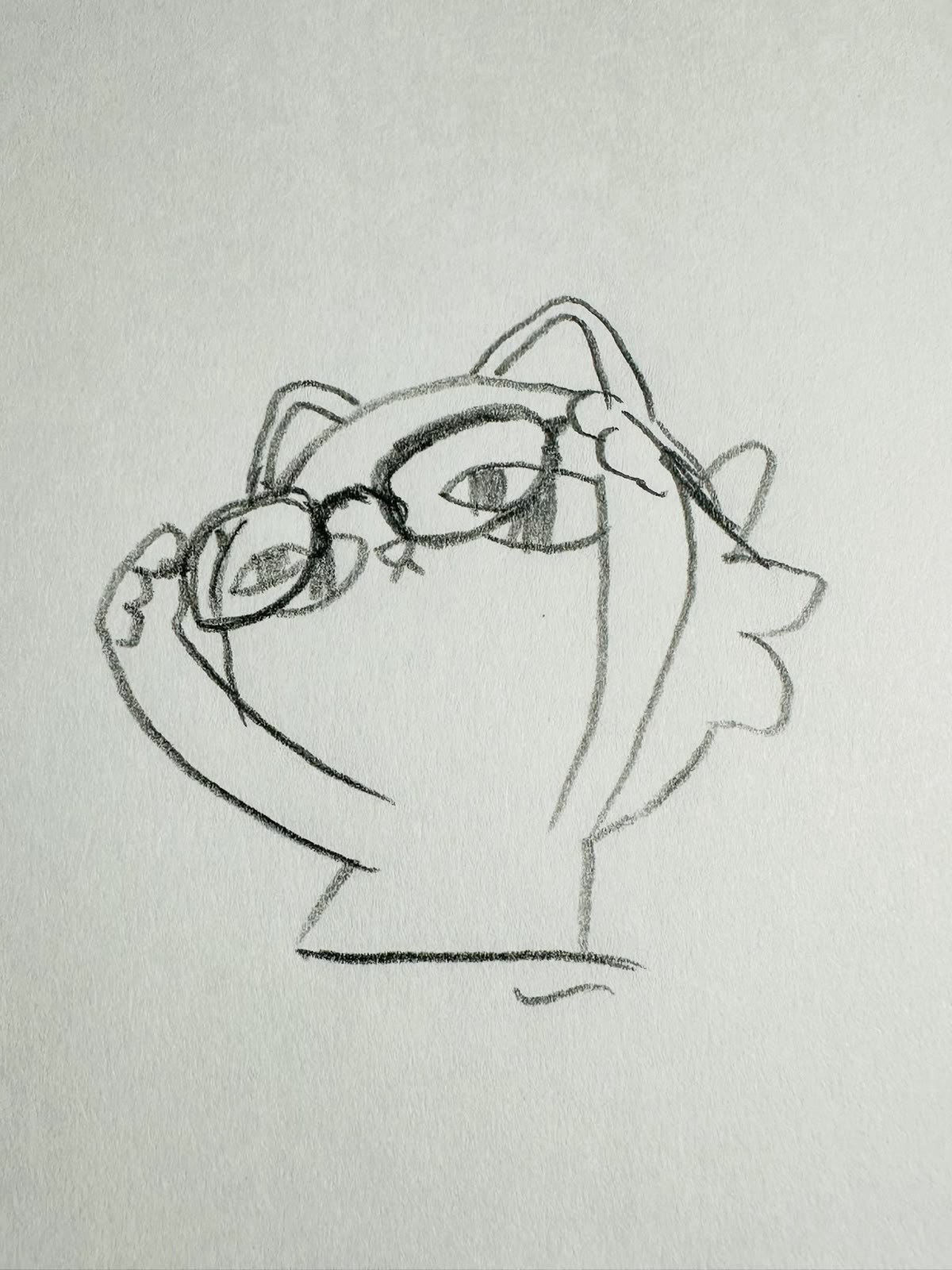 A pencil drawing of the same cat adjusting its glasses, on a page of a sketchbook.